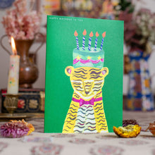 Load image into Gallery viewer, Greeting card with a tiger design and birthday cake on a green background, placed on a surface with decorative items.
