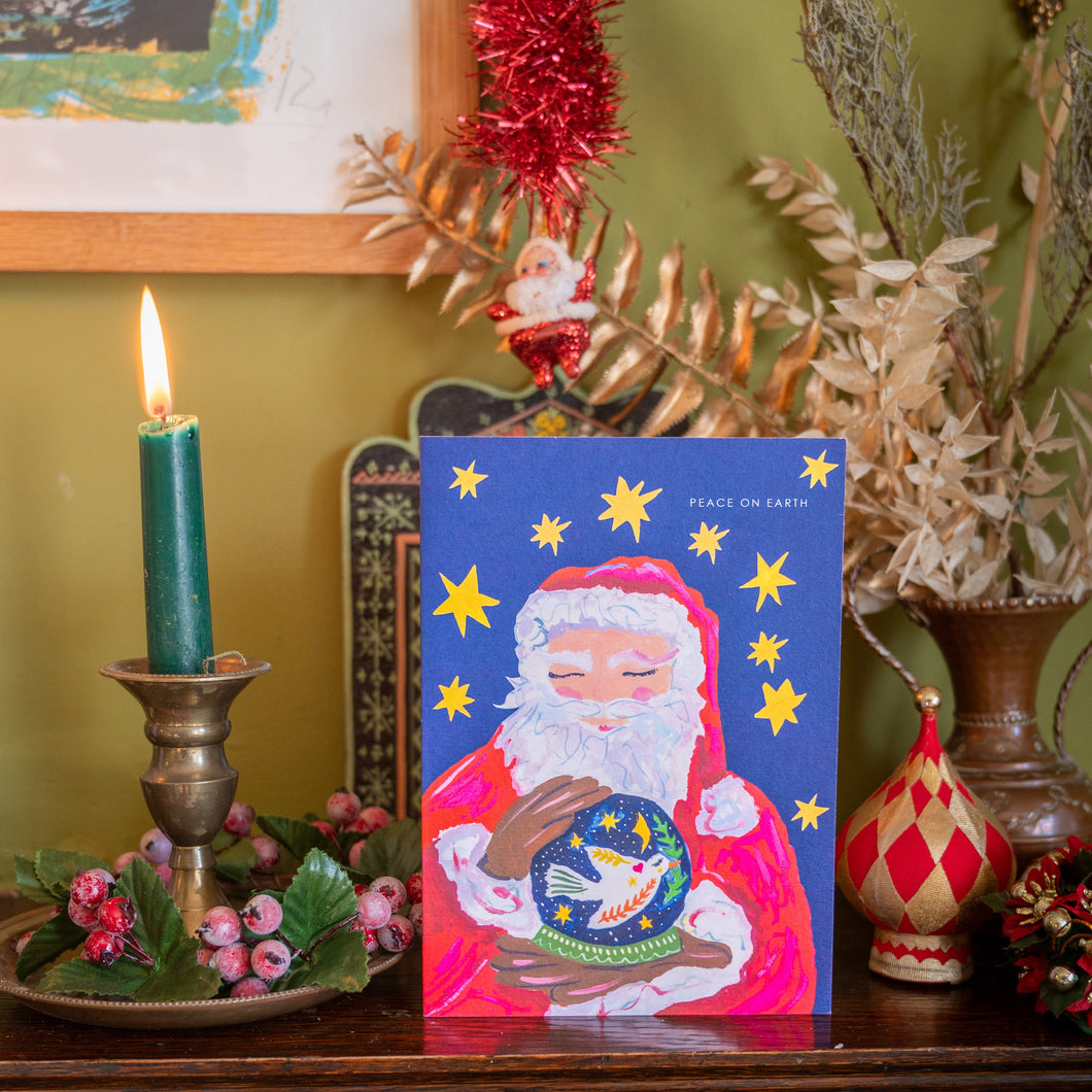 Santa with globe Christmas Card