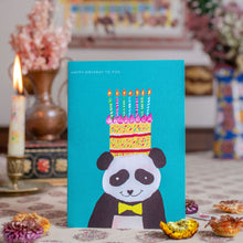 Load image into Gallery viewer, Greeting card with panda wearing a birthday cake hat on a table with decorative items.
